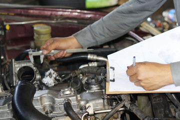 auto mechanic changing car engine