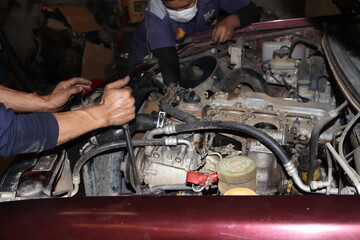 auto mechanic changing car engine