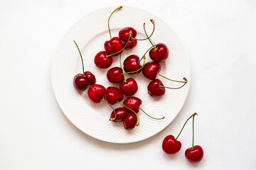Juicy cherries on a white plate