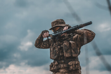 Fototapeta premium Russian soldier with a rifle against the sky. Mobilization