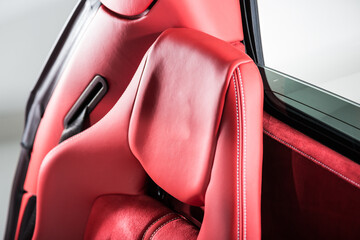 Close up of red leather headrest of luxury sports car