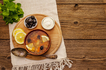 Hodgepodge, hot soup served in traditional ceramic bowl and pot. Classical Eastern Europe dish