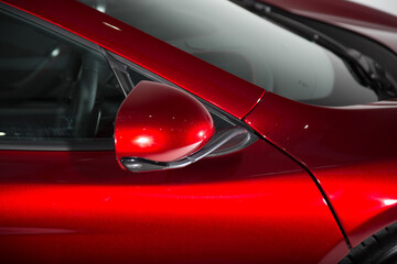 Shot of a mirror on a red sports car