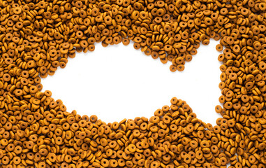 Dried dog food with a shape of fish background. Top view Brown grain pet food banner background  with copy space of test design. Above or Top view. food panorama banner.
