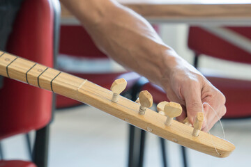 Adult hobby course,male hands playing traditional instruments.Clouse up