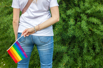 Rainbow LGBT flag in the hands of a girl, concept of gender equality. Lesbian and gay...
