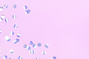 Pearl confetti on pink background. Flat lay, top view.