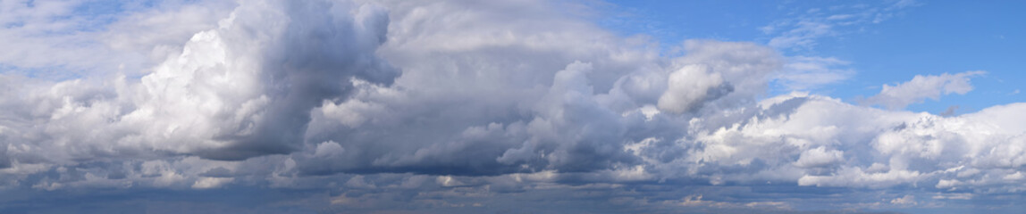  Photo of cumulus clouds.
Panoramic, horizontal image of the atmospheric phenomenon, spring season.