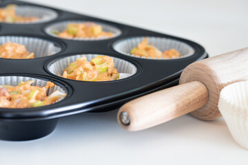 Making homemade cheese muffins, pouring dough to muffin tray. savory muffin. home made. healthy food. baking at home