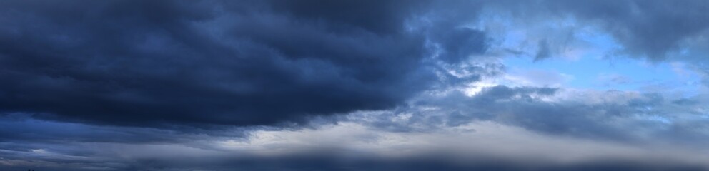 Naklejka na ściany i meble Photo of cumulus clouds. Panoramic, horizontal image of the atmospheric phenomenon, spring season.