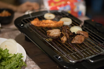 Korean BBQ. Korean BBQ Raw Beef on the Grill. grilled raw pork. Korean barbecue or yakiniku style. Beef bbq Japan. Raw beef slice for barbecue or Japanese style yakiniku