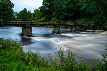 Fototapeta na wymiar Long exposure of fast flowing river at Bolton Abbey, Yokrshire