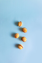 Nut cookies on a blue background. Vertical photo, flat lay