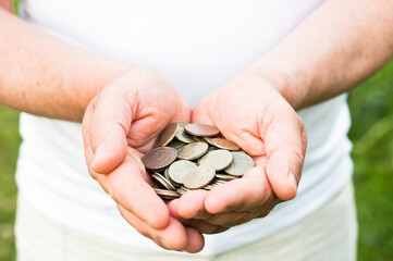 Business people use two hands to hold a lot of coins, costs and planning concept