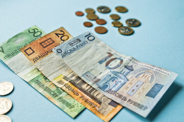Belarusian rubles and coins on a colored background