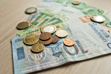 Belarusian rubles and coins on a colored background