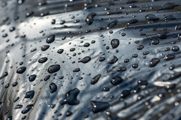 Raindrops on a black plastic bag