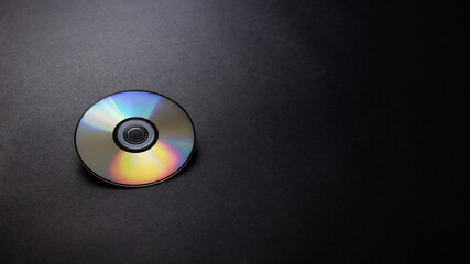 CD , DVD Disc on black texture background, desk from top view, copy space. 