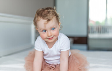 Fototapeta premium Cheerful little girl child plays in a good mood.