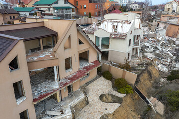 Landslide caused by rains of hurricane destroyed expensive cottages and houses. Destroyed house, cottage, large cracks, chips, slabs. Broken asphalt shifted landslide after earthquake. View from drone