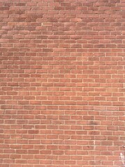 Background image of a red brick wall with running bond brickwork pattern