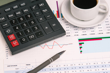 Calculator, pen and financial indicators close-up. Desk of a businessman. Statistics and monitoring the stock market. Banking, accounting and Finance