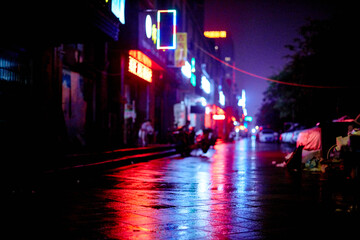 Neon lights at night in Shanghai, China. Shot on a rainy night on the backstreets. Normal life in...