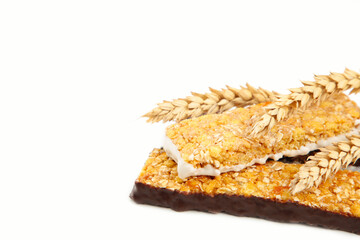 Cereal energy granola bars and spikelets of wheat isolated on white. Balanced protein breakfast.