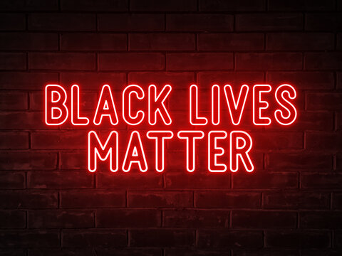 Black lives matter - red neon light word on brick wall background