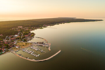 Nida city evening aerial view with yacht pier and forests in Curonian spit, Lithuania