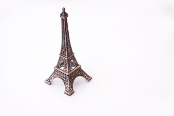 Fototapeta na wymiar Eiffel Tower on an isolated white background. Old metal figurine.
