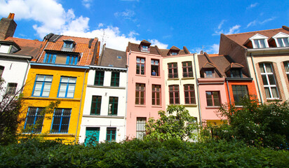 Fototapeta na wymiar Row of old colorful houses in Place Gilleson behind Notre-Dame de la Treille Cathedral in Lille, France