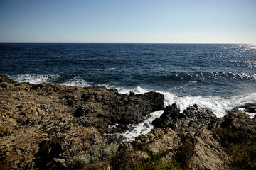 Fototapeta na wymiar Sea view from a shore. Wave on a rock. 