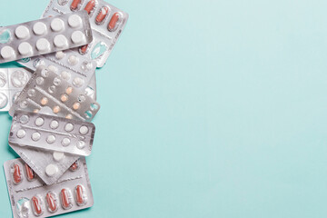 Pills blister pack on a blue background.