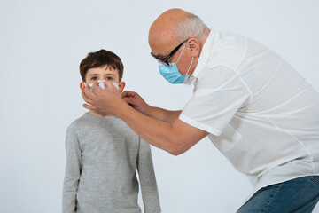 Obraz premium Father and son with face mask studio shoot white background