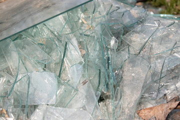 Broken glass on the ground in the street with lots of broken glass