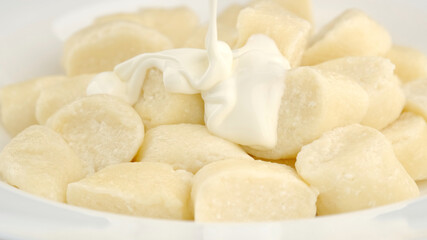 Fototapeta na wymiar lazy cottage cheese dumplings with greek yogurt in white plate. closeup