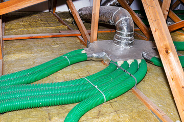 Ventilation for energy recovery in the home, visible collector and green flexible pipe connection,...