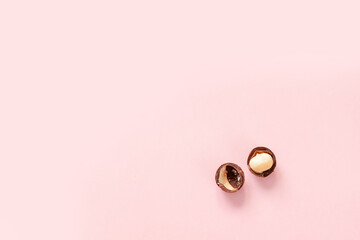 Top view of raw macadamia nut and place for text on pink background, flay lay