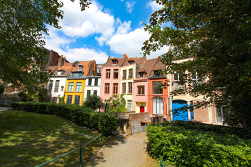 Fototapeta na wymiar Row of old colorful houses in Place Gilleson behind Notre-Dame de la Treille Cathedral in Lille, France