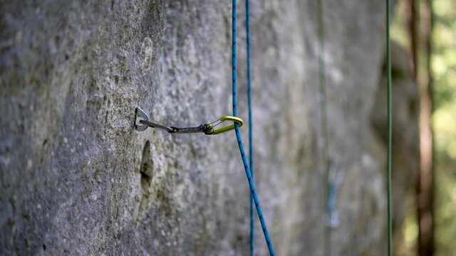 Safety rope used in rock climbing swinging on clipper in slow motion