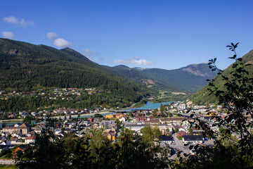 View of a mountain valley with a river below and houses. Norway. Otta