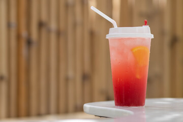 Ice with sweet water topped with Fresh pink lemonade with raspberries decorated. Brown color background. candy summer. copy space.