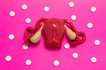 Concept photo of thyroid surgery, operation on thyroid or parathyroid gland. Doctor with scalpel in hand makes incision in figure of human thyroid, which is located near medical toolkit - stethoscope