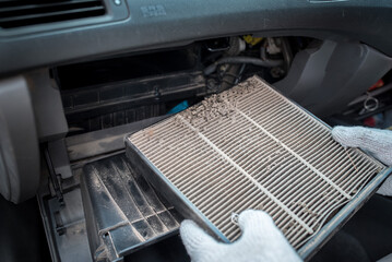 Car air conditioner filter in the cabin of the car is dirty and damaged by mice that bit The car air conditioner filter