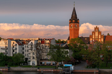 City hall clock tower aerial view of district Köpenick in Berlin, Germany with intense sky and clouds during summer sunset