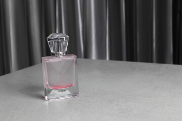 the luxury crystal spray glass of aromatic body perfume put on the grey marble stone table in the bedroom