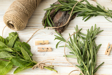 The greens on the table, rosemary and mint are getting ready for drying, summer greens