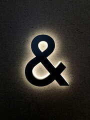 The luminous letter & on the wall at night