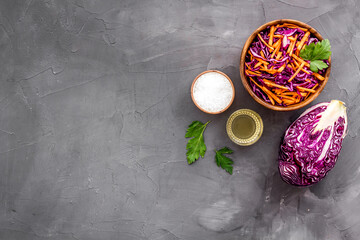Fototapeta na wymiar Healthy vegan salad with red cabbage on grey kitchen table top view copy space
